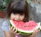 Funny portrait of an incredibly beautiful little girl blue eyes, eating watermelon, healthy fruit snack,