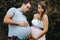 Funny portrait of pregnant wife and pregnant husband