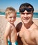 Funny portrait of young father making selfie image with his toddler son the sea beach at bright sunny. Family relaxing