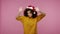 Funny positive girl afro hairstyle with Santa hat dancing and singing, feeling carefree happy, moving in energetic dance