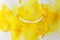 Funny positive smile face emoji made with yellow ink technique background.