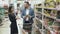 Funny positive video of young couple doing daily purchase at supermarket.