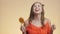 Funny pretty girl with caramel candy on colored studio background, young happy woman posing with sweet lollipop, concept food, moo