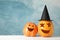 Funny pumpkins on white wooden background