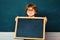 Funny pupil. Elementary school and education. Preschooler. Blackboard copy space. Little children at school lesson