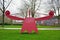 Funny red metal contemporary statue in a dutch park