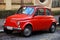 Funny red small old little italian car with round headlights and