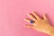 Funny ring on a little girl`s hand. Isolated on pink background