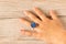 Funny ring on a little girl`s hand.  on wooden background