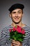 Funny romantic sailor man holding rose