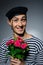 Funny romantic sailor man holding rose flowers