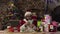 Funny Santa Claus sitting on the sofa counts a bundle of one hundred dollar bills.4k