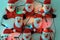 Funny santa claus toys hold tight to a white wall