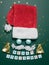 Funny Santa's face with wadded mustache eyes from balls and with a red cap. Christmas card. Flatlay composition