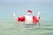 Funny Santa is swimming in the sea. Christmas in the tropics
