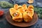 Funny sausage and cutlets mummies in dough with eyes, ketchup on table. Halloween food