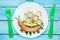 Funny sausage snail with vegetable salad