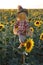 funny scarecrow stands in a sunflower field