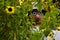 Funny scarecrow in sunflower field
