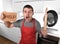 Funny scared man holding pan wearing apron at kitchen asking for help