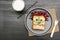 Funny scary monster face smile on halloween sandwich toast bread with peanut butter, blueberry, raspberry on plate,bats on gray