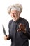 Funny senior chef with knife