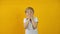 Funny shocked surprised little boy toddler on isolated yellow background