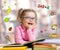 Funny smart kid in glasses reading book