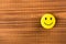 Funny smiley face on wooden background. Positive mood. Empty text space