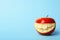 Funny smiling apple on color background.