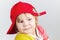 Funny smiling baby girl in red baseball cap