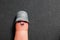 Funny smiling finger with metal thimble