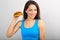 Funny smiling hungry excited woman holding in the hand the burger and looking on blue background