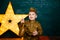 Funny smiling preschooler boy in military uniform. Boy playing soldier