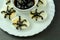 Funny snack with olive spiders on egg halves for halloween party