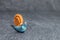 Funny snail made of play dough in front of grey background