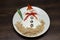 Funny snowman made of white souce in plate