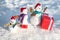 Funny snowmen family. Happy winter snowman family. Mother snow-woman, father snow-man and kid wishes merry Christmas and