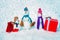 Funny snowmen family hold Christmas gift. Snowman with shopping bag and gift on the white snow background. New Year