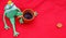 Funny soft toy prince frog with cup of tea on red carpet and fallen leaves waiting for love and princess.