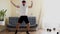 Funny stupid-looking fitness man dancing enjoying music and warming up on workout in the living room.