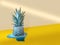 Funny stylish half-melted pineapple covered with snow,holiday stars,standing in blue puddle on yellow-gold background