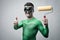 Funny superhero with painting roller thumbs up