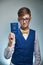 Funny teen boy with glasses holding a children`s travel passport