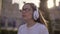 Funny teen girl listens to music on headphones and sing along 4K