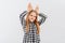 Funny teen girl standing over white background doing bunny ears gesture with hands palms looking happy and glad. Easter rabbit
