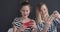 Funny teenage girls playing game on mobile phones