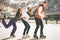 Funny teenagers girls and boy skating outdoor, ice rink