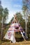 Funny tipi or wigwam with handprints in the forest.