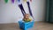Funny toddler boy sitting in plastic box imagine sailor ship. Wind blowing